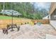 Beautiful backyard with a brick patio, colorful chairs, and a picnic table for outdoor entertaining at 160 Amherst Way, Fayetteville, GA 30215