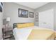 Bright bedroom featuring a cozy bed, artwork, and a large window providing natural light at 160 Amherst Way, Fayetteville, GA 30215