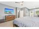 Modern bedroom with a wooden dresser, mounted TV, and neutral carpet at 160 Amherst Way, Fayetteville, GA 30215