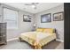 Bright bedroom with a cozy bed, artwork, and a large window providing natural light at 160 Amherst Way, Fayetteville, GA 30215