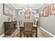 Formal dining room with stylish decor, a chandelier, and a large dining table at 160 Amherst Way, Fayetteville, GA 30215