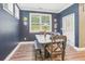 Cozy dining room with a window view, decorated with vintage-themed wall art and a rustic dining set at 160 Amherst Way, Fayetteville, GA 30215