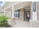 Inviting front porch featuring brick columns and a view of the front door at 160 Amherst Way, Fayetteville, GA 30215