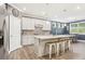 A spacious kitchen featuring white cabinets, granite countertops, stainless steel appliances, and a central island with seating at 160 Amherst Way, Fayetteville, GA 30215