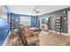 Cozy living room with a ceiling fan, stone fireplace, and built-in shelves at 160 Amherst Way, Fayetteville, GA 30215