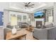 Cozy living room featuring a fireplace, built-in shelving, and a tray ceiling with fan at 160 Amherst Way, Fayetteville, GA 30215