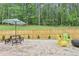Private brick patio featuring a picnic table, Adirondack chairs and views of a lovely wooded area at 160 Amherst Way, Fayetteville, GA 30215