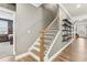 Elegant staircase with wood and iron railing, leading to the upper level at 160 Amherst Way, Fayetteville, GA 30215