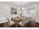 Elegant dining room featuring modern art, a wooden table, and a decorative chandelier at 3585 Roxboro Ne Rd # 2, Atlanta, GA 30326