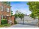 Gated entrance to community with brick facade and view of city skyline at 3585 Roxboro Ne Rd # 2, Atlanta, GA 30326
