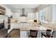 Bright kitchen with stainless appliances, granite countertops, white cabinetry, hardwood floors, and a breakfast bar at 3585 Roxboro Ne Rd # 2, Atlanta, GA 30326