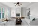 Open living room with a fireplace, large windows, and views of the stairway at 3585 Roxboro Ne Rd # 2, Atlanta, GA 30326