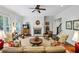 Open living room featuring a fireplace, a ceiling fan, and hardwood flooring at 3585 Roxboro Ne Rd # 2, Atlanta, GA 30326