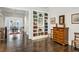 Open living room featuring hardwood floors, custom built-ins, and neutral paint at 3585 Roxboro Ne Rd # 2, Atlanta, GA 30326