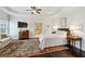Bright main bedroom featuring tray ceiling, plush rug, and ensuite bathroom entrance at 3585 Roxboro Ne Rd # 2, Atlanta, GA 30326