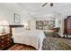 Bright main bedroom featuring tray ceiling, plush rug, and elegant built-in bookcase at 3585 Roxboro Ne Rd # 2, Atlanta, GA 30326