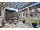 Charming outdoor patio with pergola, featuring a table with chairs and potted plants under a sunny sky at 3585 Roxboro Ne Rd # 2, Atlanta, GA 30326
