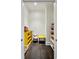 Bright room with hardwood floors, yellow storage unit, and lots of natural light at 3585 Roxboro Ne Rd # 2, Atlanta, GA 30326