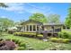 Beautiful backyard with lush landscaping, a deck, and a sunroom at 733 Huntington Se Pl, Marietta, GA 30067