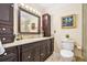 Bathroom featuring dark wood vanity, granite countertops and large framed mirror at 733 Huntington Se Pl, Marietta, GA 30067