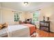 Bright bedroom with hardwood floors, two windows, desk and bookcase at 733 Huntington Se Pl, Marietta, GA 30067