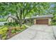 Charming home featuring a lush front yard with manicured landscaping and mature trees, creating inviting curb appeal at 733 Huntington Se Pl, Marietta, GA 30067