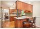 Well-lit kitchen with granite countertops, mosaic backsplash, wood cabinets and stainless steel refrigerator at 733 Huntington Se Pl, Marietta, GA 30067