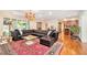 Open-concept living room with hardwood floors, large windows, and stylish furnishings for modern comfort at 733 Huntington Se Pl, Marietta, GA 30067