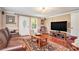 Inviting living room with hardwood floors, leather sofa, TV, front door and large area rug at 733 Huntington Se Pl, Marietta, GA 30067