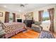 Cozy main bedroom features a ceiling fan, hardwood floors, and ample natural light at 733 Huntington Se Pl, Marietta, GA 30067