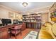 Spacious office with built-in bookshelves, desk, and comfortable seating area at 733 Huntington Se Pl, Marietta, GA 30067