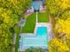 Aerial view showcasing a community pool with lounge areas and lush surrounding greenery at 733 Huntington Se Pl, Marietta, GA 30067