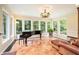 Bright sunroom with floor-to-ceiling windows, marble floors, and comfortable seating for relaxation at 733 Huntington Se Pl, Marietta, GA 30067