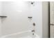 Contemporary bathroom highlighting the tub-shower combination and sleek white tile at 1583 Braeburn Se Dr, Atlanta, GA 30316