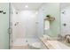 Renovated bathroom featuring a frameless glass shower with marble tile surround at 1583 Braeburn Se Dr, Atlanta, GA 30316