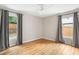 This bedroom features hardwood floors and two windows at 1583 Braeburn Se Dr, Atlanta, GA 30316