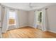 Well-lit bedroom with hardwood floors and bright windows covered by white curtains at 1583 Braeburn Se Dr, Atlanta, GA 30316