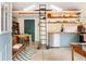 Modern kitchen featuring stainless steel appliances, wood shelving, and a loft ladder for added charm at 1583 Braeburn Se Dr, Atlanta, GA 30316