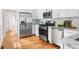 Bright kitchen featuring stainless steel appliances, white cabinets and beautiful granite countertops at 1583 Braeburn Se Dr, Atlanta, GA 30316