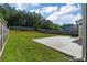 Expansive backyard with mature trees and a concrete patio area at 211 Augusta Woods Dr, Villa Rica, GA 30180