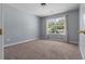 Bedroom with carpet, neutral walls, a window overlooking the yard, and a ceiling fan at 211 Augusta Woods Dr, Villa Rica, GA 30180