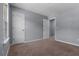 Bedroom with carpet, two closets, neutral walls, and a window with views of the neighborhood at 211 Augusta Woods Dr, Villa Rica, GA 30180