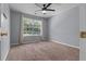 Bedroom with carpet, a window with backyard views, neutral walls, and white trim at 211 Augusta Woods Dr, Villa Rica, GA 30180