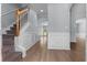 Inviting entryway with wood floors, staircase, and decorative wainscoting for an elegant touch at 211 Augusta Woods Dr, Villa Rica, GA 30180