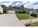 Charming two-story home with brick accents, a well-manicured lawn, and a spacious driveway at 211 Augusta Woods Dr, Villa Rica, GA 30180