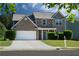 Charming two-story home with stone accents, manicured lawn, and a two car garage at 211 Augusta Woods Dr, Villa Rica, GA 30180