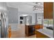 Island kitchen with stainless steel appliances and an open view into the Gathering room at 211 Augusta Woods Dr, Villa Rica, GA 30180