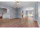 Open-concept living room with archways, hardwood floors, and natural light enhancing the space at 211 Augusta Woods Dr, Villa Rica, GA 30180