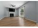 Comfortable living room with a fireplace, ceiling fan, and large window for natural light at 211 Augusta Woods Dr, Villa Rica, GA 30180