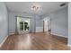 Bright living room featuring hardwood floors, a large window, and an open entryway at 211 Augusta Woods Dr, Villa Rica, GA 30180